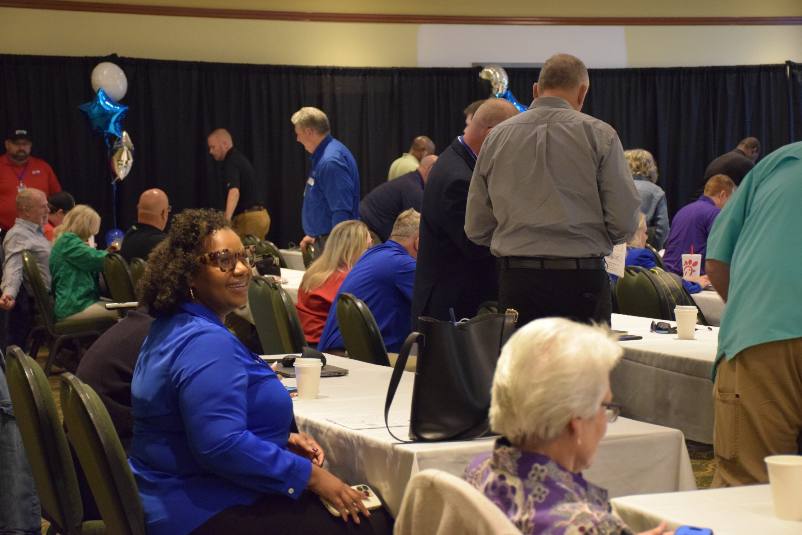Attendees move about a conference room at the 2024 TIME Task Force Conference.