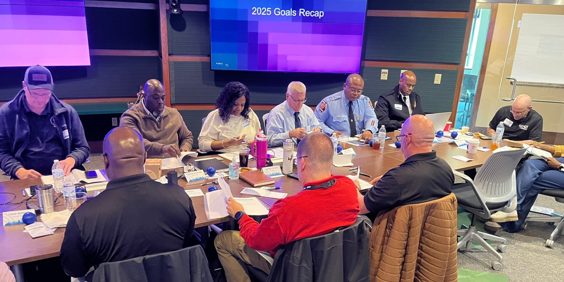 Candid photo of the Board of Directors working together at a conference table. 